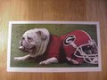 Picture: Georgia Bulldogs "Greatest Catches" autographed UGA with Helmet Art Poster. Lindsay Scott hand-signed this poster and added "Run Lindsay Run." Verron Haynes hand-signed this poster and added "P 44 Haynes" which is the name of the play on which he made the winning catch and Georgia still runs and calls it this. Mikey Henderson hand-signed this poster and added "One and Done." The autographs are all guaranteed authentic and come with a Certificate of Authenticity from us.