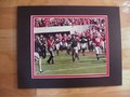 Picture: Kirby Smart leads the Georgia Bulldogs original 8 X 10 photo professionally double matted in team colors to 11 X 14 so that it fits a standard frame.